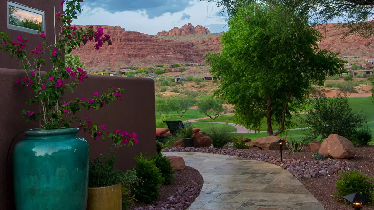 a path winding around a corner, with planted pots on either side