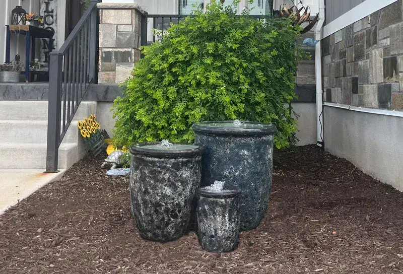 Triple water fountain in front of a home