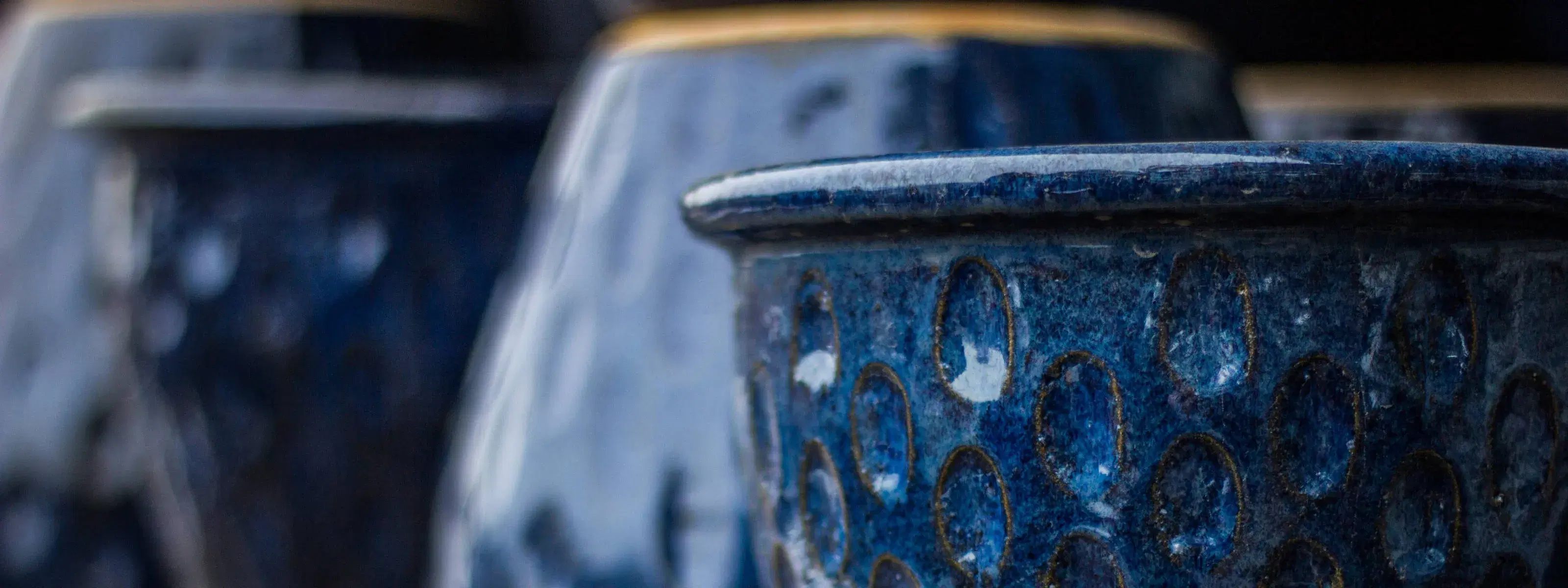 close up of glazed, blue, outdoor pottery