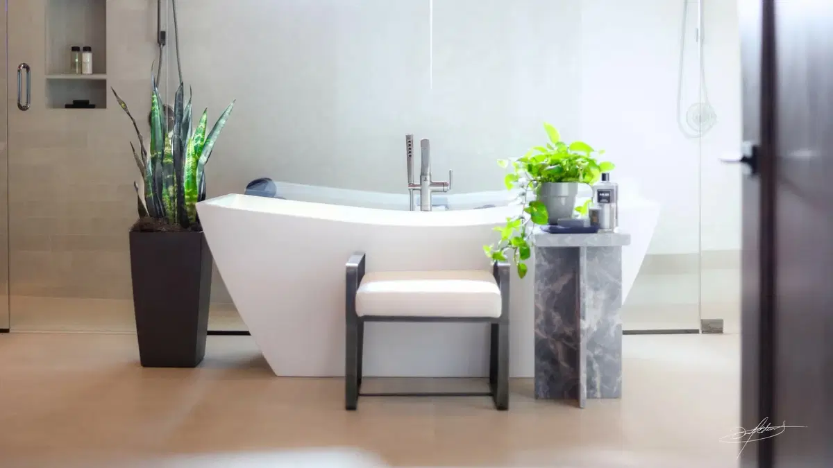 a modern bathroom, tastefully plantscaped with small pottery