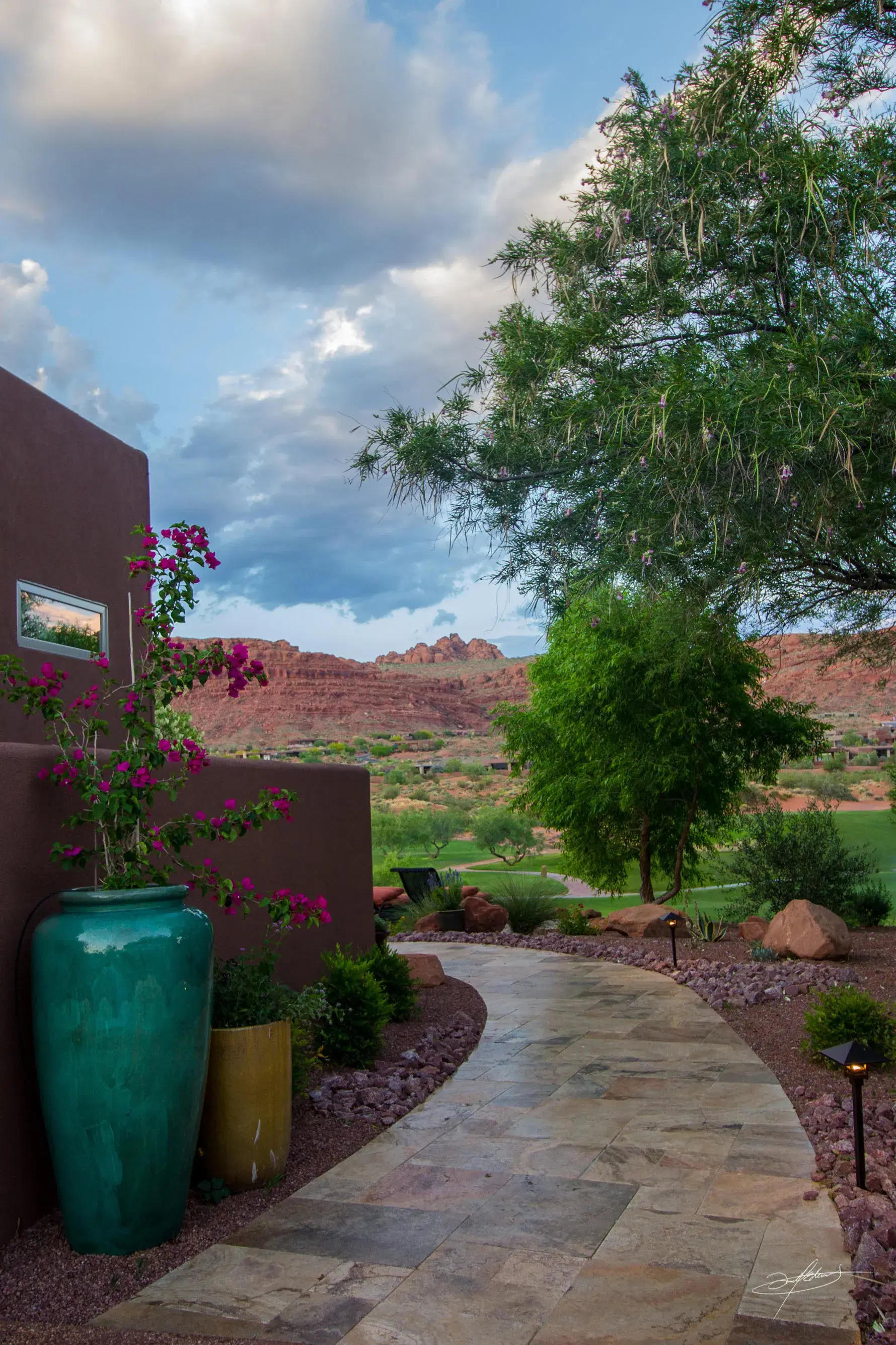 tall outdoor ceramic pottery lining a curving path