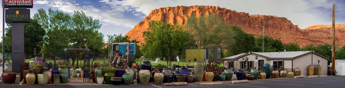 a wide shot of the botanicals saint george lot, with the red hills in the background