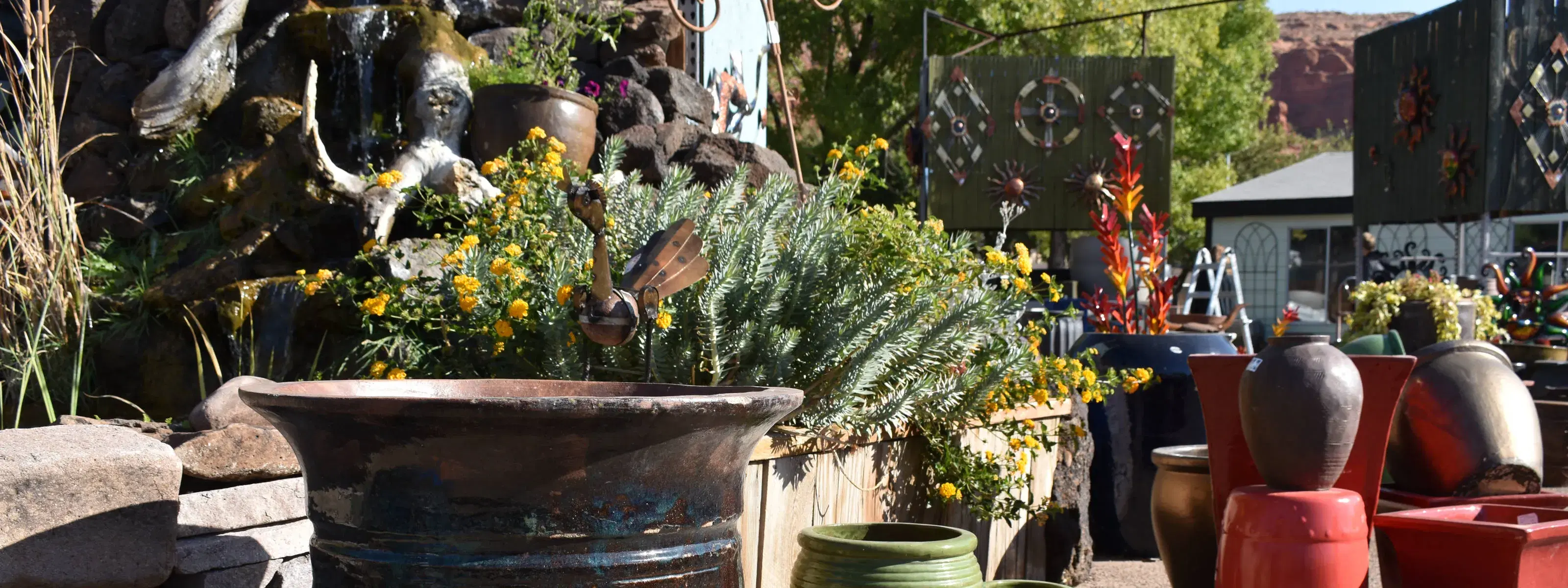 a metal roadrunner perched on a ceramic pot in our saint george retail lot