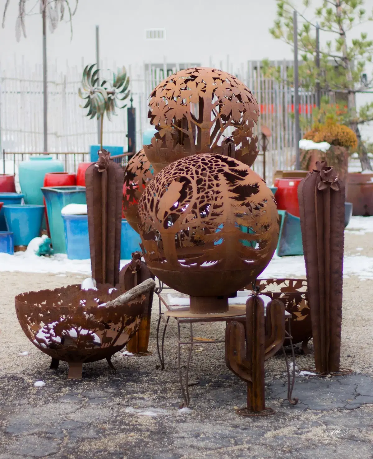 rustic, metal fire globes and cactus arranged in a display