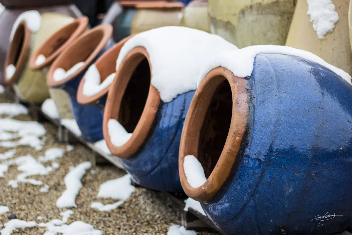 high fired pottery with snow collected on top